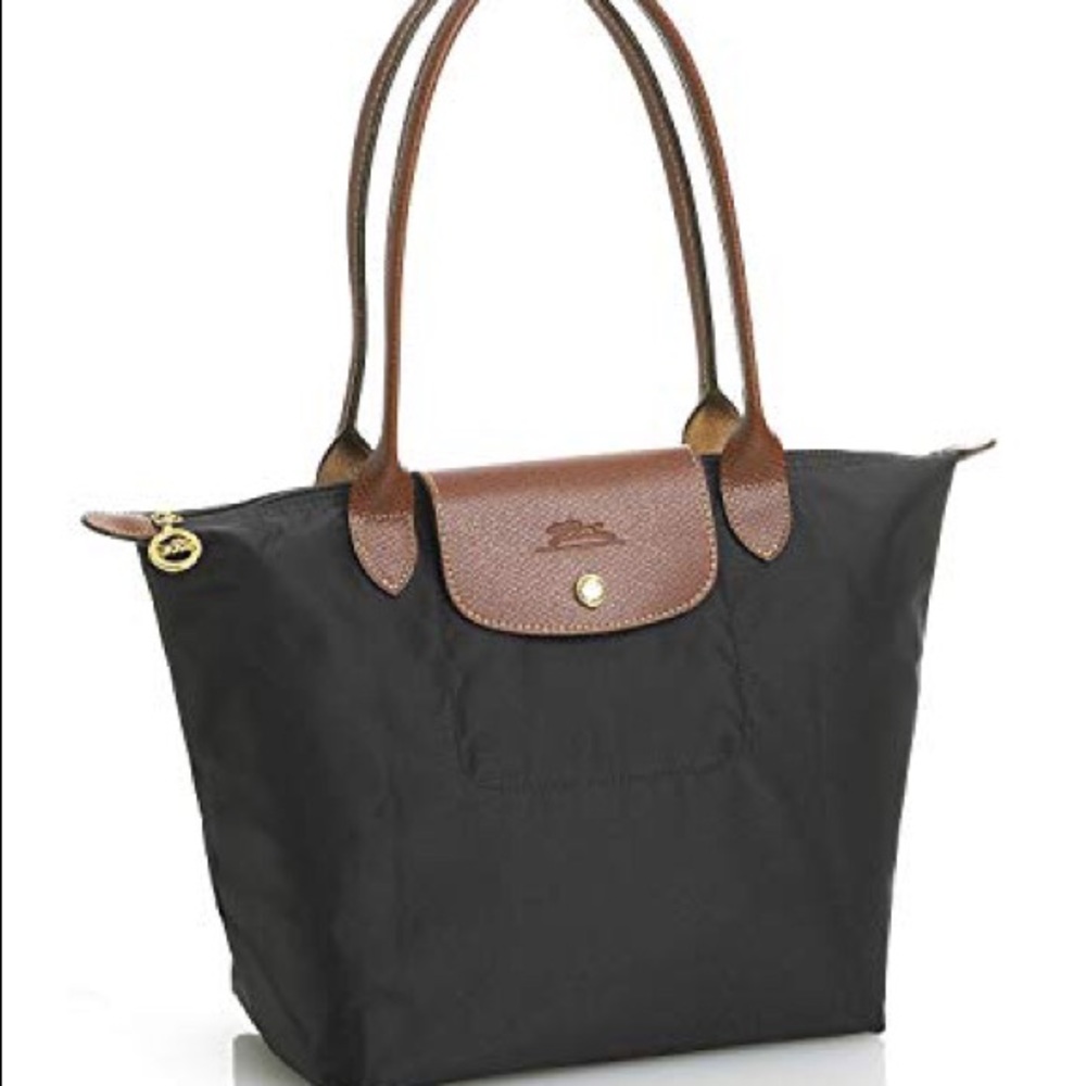 Black tote bag: brand is “Longchamp”